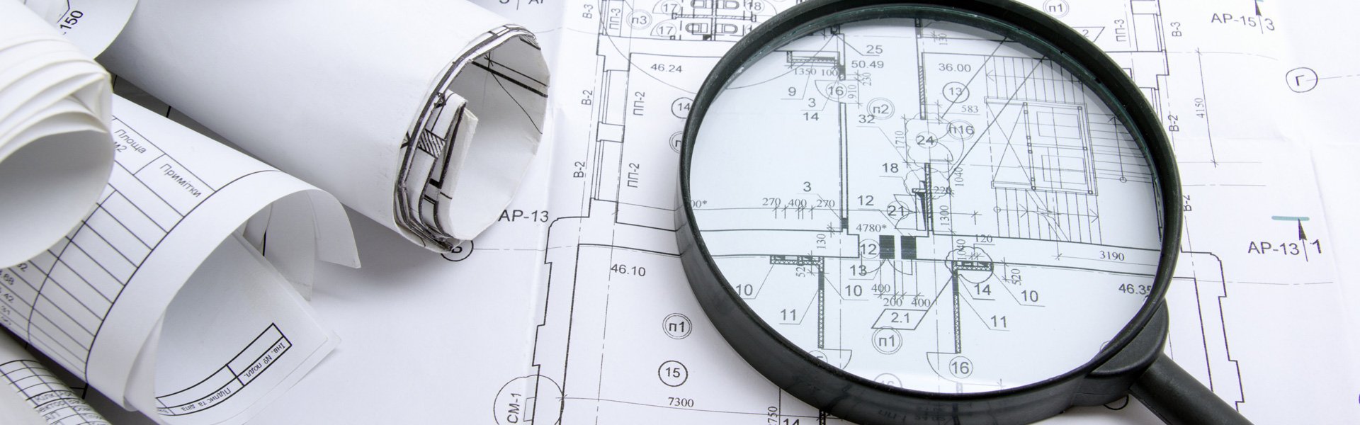 Magnifying glass on blueprints